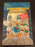 Front cover of Donald Duck Adventures comic showing Donald Duck and nephews with castle background and comic details including issue number, price, and date.