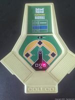 Front view of the Coleco Head-to-Head Electronic Baseball handheld game showing the baseball diamond layout with red LED indicator lit at home base and scoreboard window. Beige plastic casing with Coleco logo at bottom.