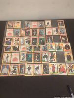 Photo showing 50 front view trading cards featuring New Kids on the Block members in different poses with colorful 1989 style borders.