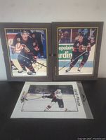 Two framed signed Ottawa Senators 8x10 photos, Alexei Yashin and Alexander Daigle, with a loose photo below.