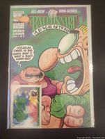 Full shot of the Ralph Snart Adventure Mind Games Part 1 comic cover sealed in a protective sleeve showing main characters and trading card included.