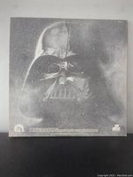 Back side of the vinyl album cover showing a large Darth Vader illustration in grey tones with space background.