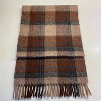 Full view of the folded wool scarf showing the checkered pattern and fringed ends