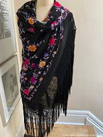 Shawl draped on mannequin front showing overall design and fringe