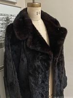Front view of full length mink fur coat on mannequin