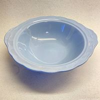 Side view of one robin egg blue Grindley Lupin Petal bowl showing scalloped edges and handle detail