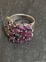 Side view of the vintage sterling silver ring showing the cluster of pink amethyst stones and marcasite decoration.
