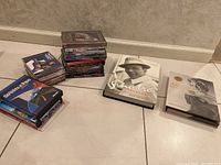 Collection arrangement showing stacks of DVDs, CDs, and books with included CD/DVD