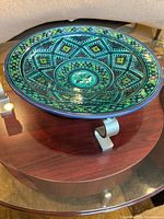 Top angle showing the bowl's full design, emphasizing geometric patterns and color palette.