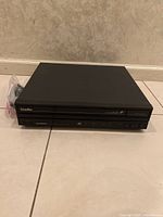 Black Pioneer LaserDisc player model LD-8380D front view on floor.