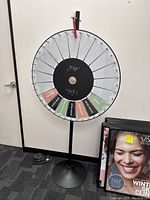 Front view showing wheel segments, pointer and base