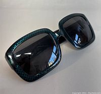 Front view of oversized square frames and dark tinted lenses