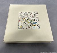 Closed box with colorful Houses of the Holy album cover art on front.