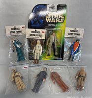 Overall lot showing all 8 Star Wars figures including the Han Solo figure in blister packaging and 7 preowned bagged figures.