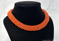 Choker displayed on black velvet bust showing full front view of beadwork and fit.