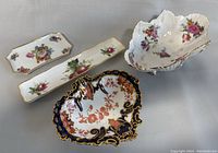 Four assorted vintage porcelain dishes, including footed bowl and Aynsley dishes with floral designs and gold trim.