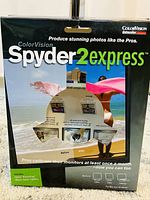 Front view of ColorVision Spyder2express box showing product name, images demonstrating calibration effect, and included software.