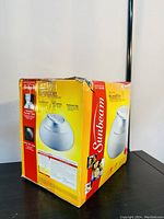 Photo of the humidifier box showing the product image and listing details, with box showing some wear.