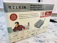 Box front and side view showing brand, product type Wireless G Router, wireless speed 54 Mbps, frequency 2.4 GHz, and sealed condition.