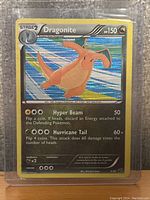 Front holographic display of the Dragonite Pokémon card showing illustration, stats, and attacks.