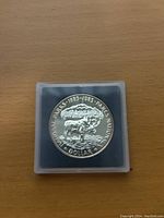 Front side of the coin showing a moose and mountain scenery with inscriptions commemorating National Parks Canada 1885-1985.