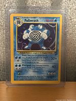 Front view of vintage Poliwrath Pokemon card showing illustration, HP, moves, and details.