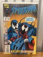 Front cover photo of Spider-Man issue 52 comic showing Venom and Spider-Man characters with storyline text.
