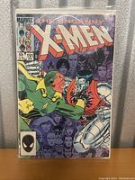 Front cover of Uncanny X-Men issue #191 comic book in protective sleeve, featuring cover art with X-Men characters Colossus and another character confronting each other.
