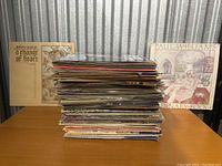 Stack of vinyl records showing various album covers including Golden Avatar and Paul Williams