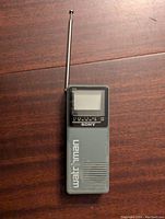 Front view of Sony Watchman portable TV showing screen, speaker, tuning scale, brand and product name.