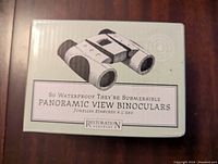 Box front showing the product name and image indicating waterproof submersible binoculars.