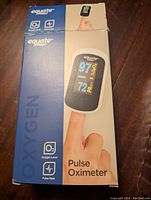 Front side of the Equate Pulse Oximeter box showing the device image with finger inserted, displaying oxygen saturation (97%) and pulse rate (72 bpm).