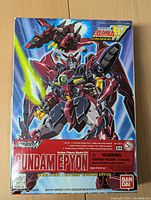 Front of Bandai Gundam Epyon model kit box showing colorful artwork of the Gundam Epyon robot and its dragon head form in space background.