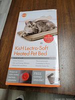 Front view of unopened K&H Lectro-Soft Heated Pet Bed box showing product name, features, and image of a cat lying on the bed.