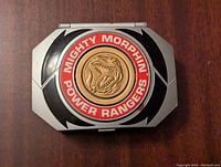 Top view of the closed playset showing Mighty Morphin Power Rangers Red Ranger emblem with Tyrannosaurus medallion.