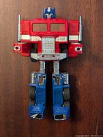 Front view of Transformer Generation 2 Optimus Prime figure showing detailed head, chimney smokestacks on shoulders, and red and blue color scheme.