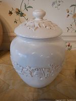 Close-up of the white grapevine design cookie jar with lid
