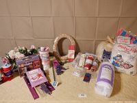 Overview of the crafting items showing Bowdabra box, ribbons, artificial flowers, wreath, floral foam, fabrics, and batting.