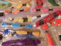 Photo showing multiple skeins of colorful embroidery thread packed in clear plastic bags