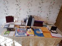 Full view of table with all stationery, binders, envelopes, and paper supplies spread out