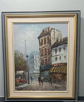 Frontal view of framed oil painting depicting a Paris street scene