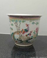 Front view of the planter showing colorful exotic birds and floral decorations.