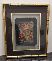 Framed original print showing bamboo style frame and black mat with gold accent.