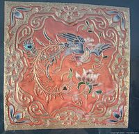 Square silk embroidery panel on coral background showing full design of phoenix, flowers, and border.