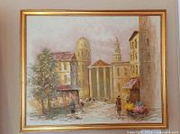 Frontal image showing full painting and gilt frame hanging on wall. Depiction of Paris street scene with buildings, dome, walking people, and tree.