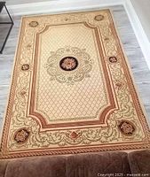 Full view of large rectangular Turkish floor rug showing overall pattern and size against flooring.