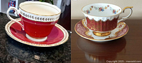 Two teacup and saucer sets: left Paragon with cranberry and gold design, right Aynsley with cranberry and floral gold design