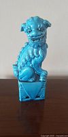 Front view of turquoise blue glazed porcelain lion Foo Dog statue figurine.