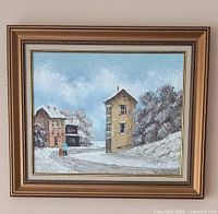 Framed winter scene oil painting by David Crespi showing buildings and trees under snowy conditions.
