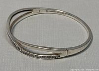 Silver Pandora bracelet with crystal detail, showing open and closed view.